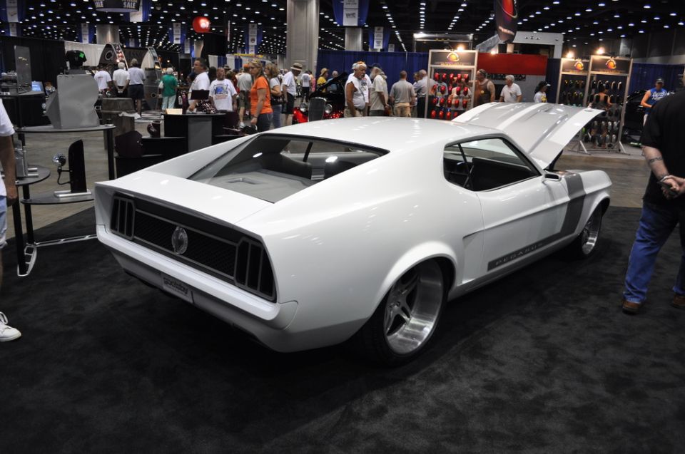 White 1969 Ford Mustang with racing stripes, hood open