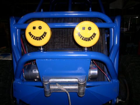 1979 Ford Bronco - This buggy features a prominent winch and two yellow KC Daylighter lights mounted on its blue roll cage.