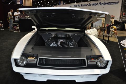 2007 Ford Mustang - A customized muscle car is displayed with its hood open, revealing a powerful engine and a prominent 'MM' badge.