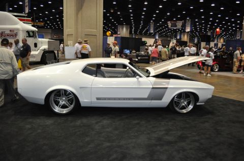 2007 Ford Mustang - A modified 1971 Ford Mustang is displayed indoors with its hood open, custom wheels and side graphics.