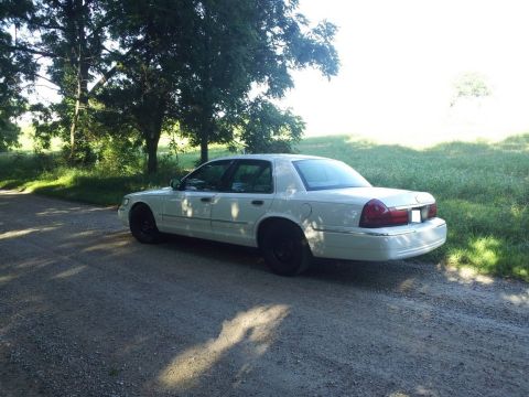 2000 Mercury Grand Marquis - White 2000 Mercury Grand Marquis parked on a gravel road.