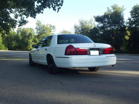2000 Mercury Grand Marquis - Rear view of a white 2000 Mercury Grand Marquis parked outdoors.
