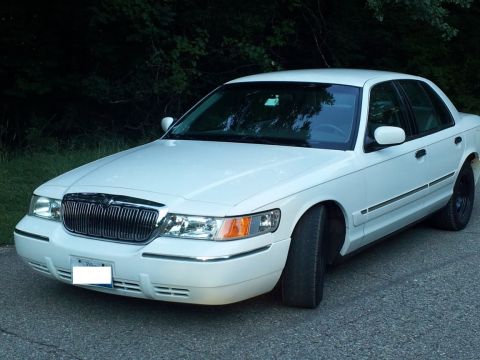 2000 Mercury Grand Marquis - This 2000 Mercury Grand Marquis is shown from a 3/4 front angle, highlighting its distinctive chrome grille.