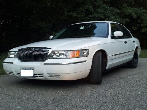 2000 Mercury Grand Marquis - Front 3/4 view of a white 2000 Mercury Grand Marquis sedan.