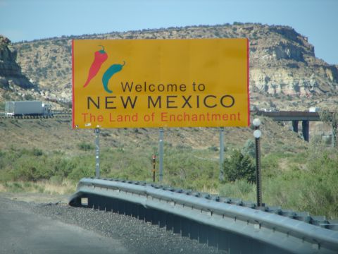 1992 Ford Taurus - Welcome to New Mexico sign, chili peppers and the state's slogan, 'The Land of Enchantment'.