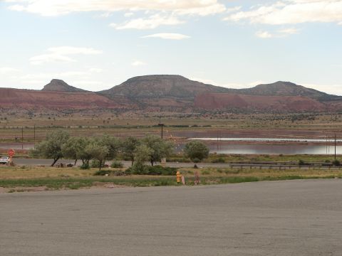 1992 Ford Taurus - A white sedan is visible on the left side of the frame, with a scenic mountain landscape behind it.