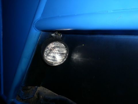1979 Ford Bronco - A close-up view shows a single off-road light mounted to a blue tubular structure.