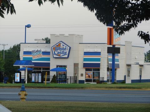 1992 Ford Taurus - A White Castle restaurant is seen with its distinctive blue and white branding, including awnings and the iconic castle logo.