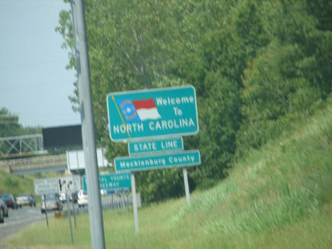1992 Ford Taurus - Sign indicates entry into North Carolina and Mecklenburg County.