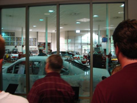 1992 Ford Taurus - A car is visible inside a workshop, with people looking in through the windows.