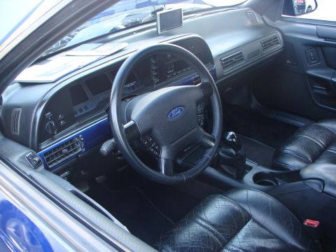 1992 Ford Taurus - The interior of a 1992 Ford Taurus features a blue trim accent on the dashboard and black leather seats.