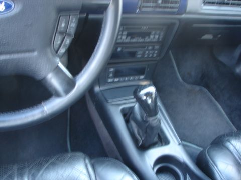 1992 Ford Taurus - The interior of a 1992 Ford Taurus, its dashboard and gear shifter, is captured from the driver's perspective.
