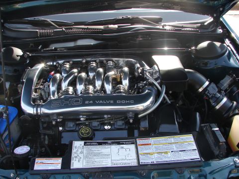 1992 Ford Taurus - The engine bay of a 1992 Ford Taurus SHO is visible, a polished 24-valve DOHC engine.