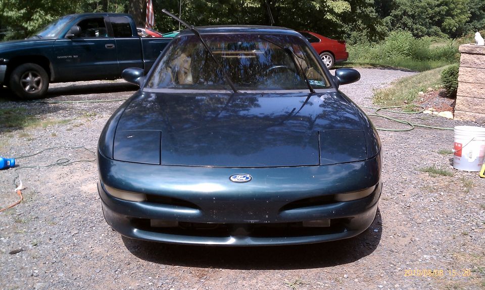 1997 Ford Probe front view, parked outside with a pickup truck and a red car in the background