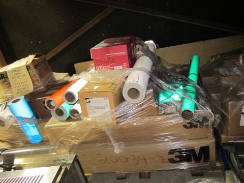 1991 Ford LTD Crown Victoria - A collection of supplies, including rolls of reflective material and boxes, are stacked and wrapped in plastic.