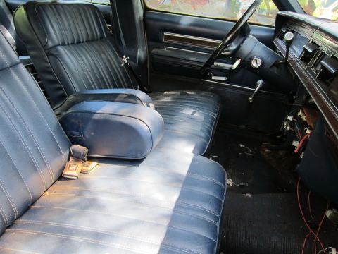 1991 Ford LTD Crown Victoria - Interior view of a car, showing bench seats, armrest, steering wheel, and dashboard.