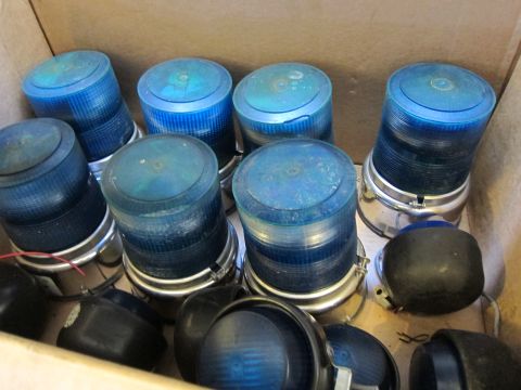 1991 Ford LTD Crown Victoria - Several blue strobe lights are packed together in a cardboard box, ready for use or storage.