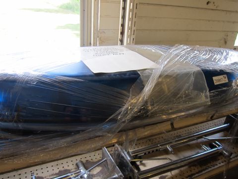 1991 Ford LTD Crown Victoria - A blue car fender, wrapped in plastic, sits on a shelf with a label indicating '20007-2'.