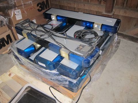 1991 Ford LTD Crown Victoria - Multiple emergency light bars are stacked on a wooden pallet, wrapped in plastic.