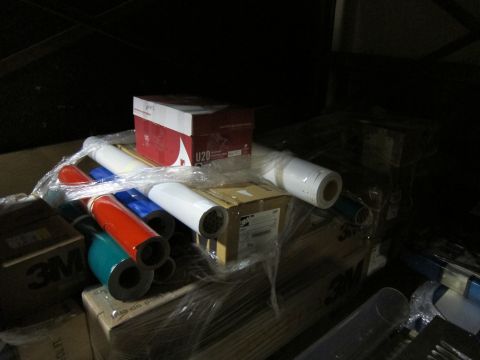 1991 Ford LTD Crown Victoria - Various rolls of vinyl wrap and boxes are stored together, some labeled with 3M branding.