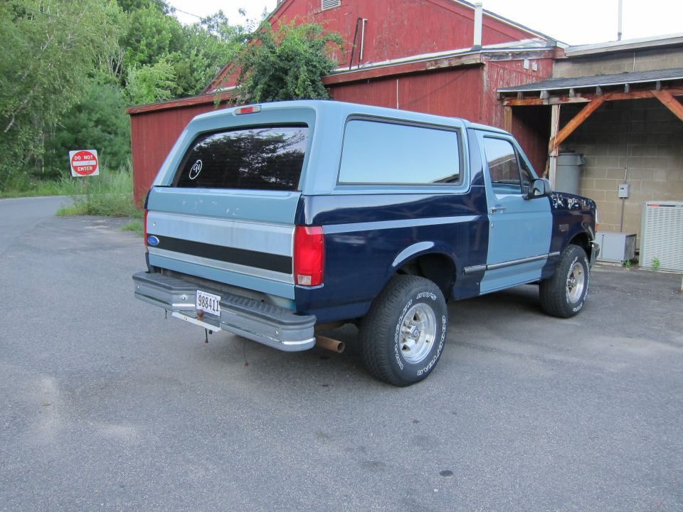 Two-tone blue Ford Bronco rear view with chrome bumper and license plate