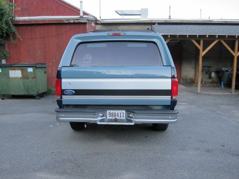 2001 Ford Crown Victoria - Rear view of a blue Ford Bronco, likely a 1996 model, parked outdoors.
