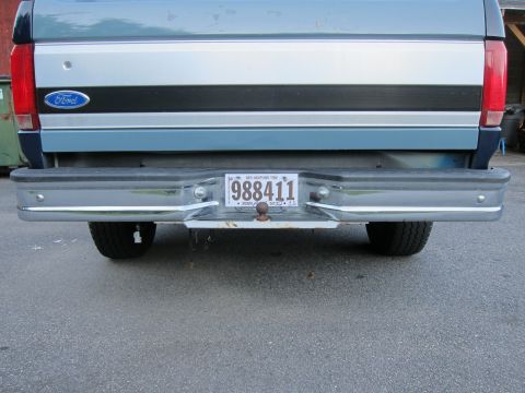 2001 Ford Crown Victoria - Rear view of a blue and silver Ford truck, showing its bumper and license plate.