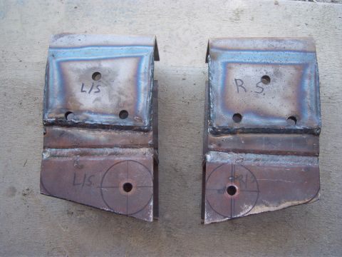 1996 Ford Bronco - Two custom-fabricated metal brackets, marked for left and right sides, are shown before installation.