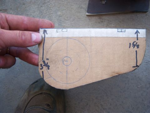 1996 Ford Bronco - A hand holds a cardboard template with drawn circles and measurements, likely for a vehicle part.