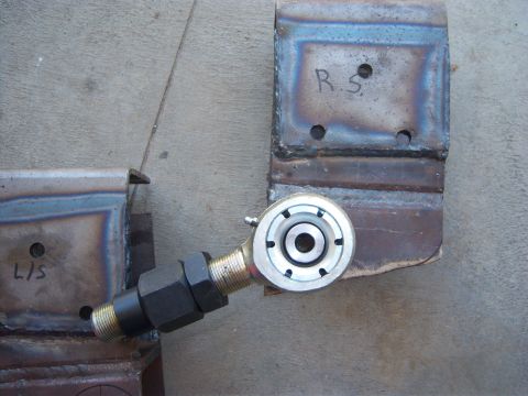 1996 Ford Bronco - A close-up shows a rod end joint connected to a metal bracket, with another bracket labeled 'L/S' visible on the left.