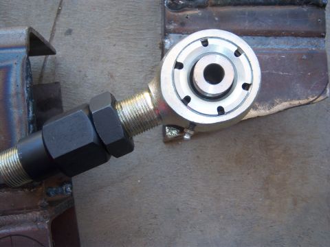 1996 Ford Bronco - Close-up of an adjustable suspension part, likely for a vehicle, held in a vise.