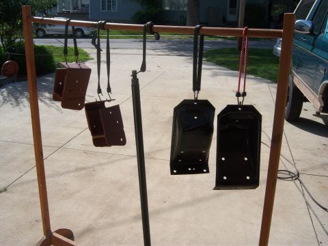 1996 Ford Bronco - Metal parts are hung on a rack for painting, with a teal truck partially visible in the background.