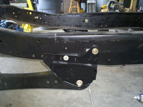 1992 Ford Bronco - Close-up view of vehicle frame rails and a bolted bracket.