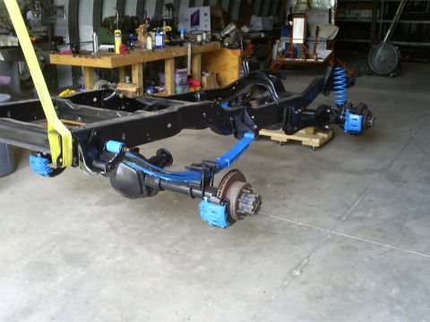 1992 Ford Bronco - A vehicle frame and suspension system are shown, with blue-painted parts and disc brakes visible.