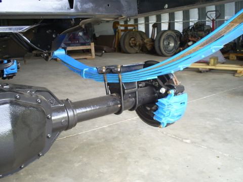 1992 Ford Bronco - The rear axle assembly features new blue leaf springs and brake calipers, suggesting recent maintenance or upgrades.