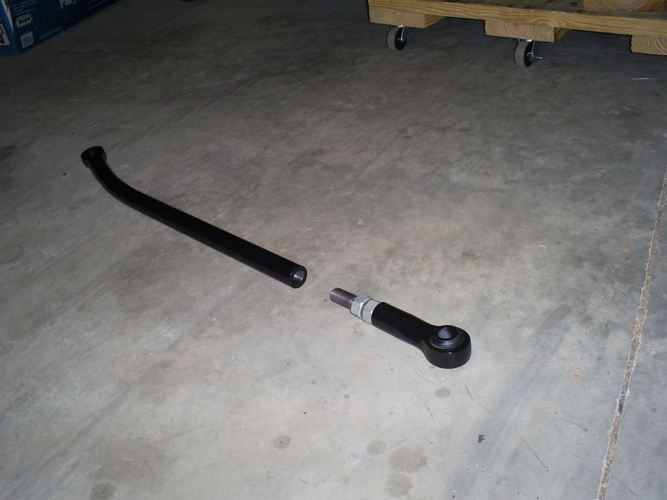 Black tie rod assembly on concrete floor
