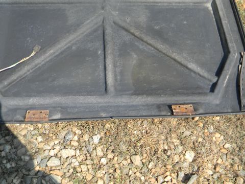 1979 Ford Ranchero - Underside of a car hood with visible bracing and hinges, and a wire harness.