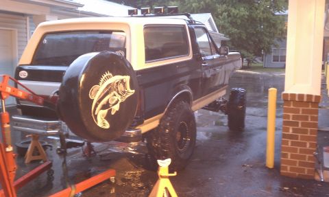 1990 Ford Bronco - Ford Bronco with custom spare tire cover, lifted suspension, and roof rack.