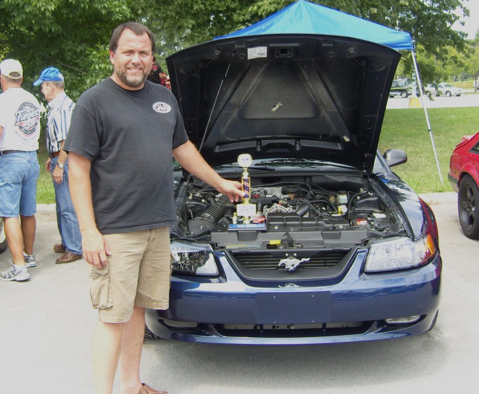 Blue 2007 Ford Mustang front view, hood open, with trophy