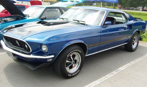 2007 Ford Mustang - A classic blue 1969 Ford Mustang Mach 1 is parked at an outdoor car show.