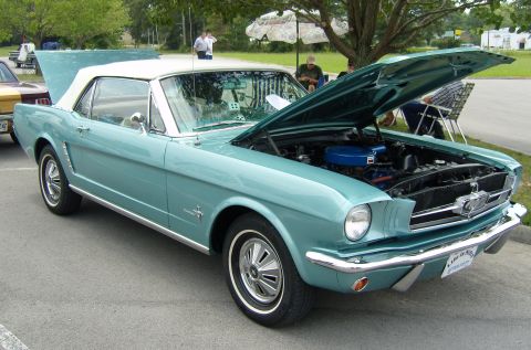 2007 Ford Mustang - A teal 1965 Ford Mustang convertible is displayed with its hood open, revealing the engine bay.