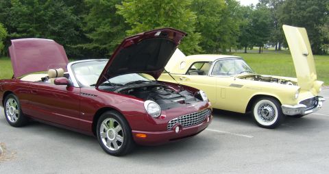 2007 Ford Mustang - A pair of Ford Thunderbirds, a classic 1957 model and a modern convertible, are displayed with their hoods open.