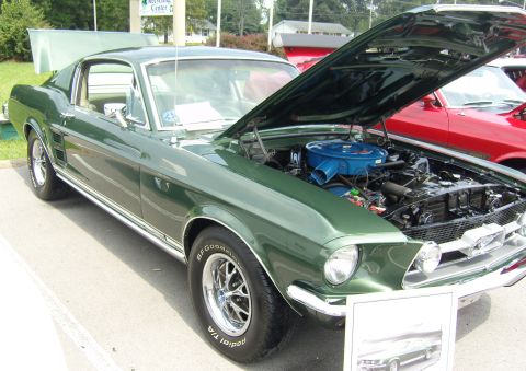 2007 Ford Mustang - A green 1967 Ford Mustang fastback is displayed with its hood open, revealing the engine bay.