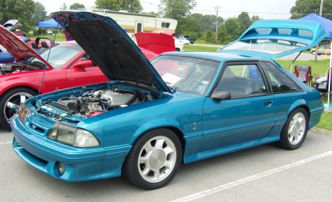 2007 Ford Mustang - A teal 1987 Ford Mustang coupe is displayed with its hood and trunk open, revealing the engine bay.