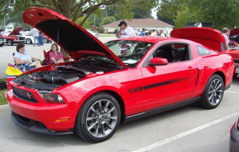 2007 Ford Mustang - A red 2007 Ford Mustang GT/CS is displayed with its hood and trunk open at a car show.