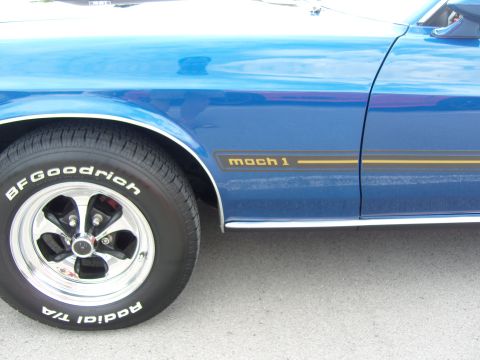 2007 Ford Mustang - Side profile of a blue car with a "mach 1" decal and classic BFGoodrich tires.