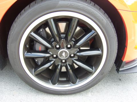 2007 Ford Mustang - Close-up of a black Ford Mustang wheel with a silver lip, showing a Brembo brake caliper and a Pirelli P Zero tire.