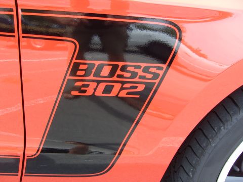 2007 Ford Mustang - Close-up of a BOSS 302 decal on the side of an orange vehicle.