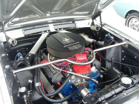 2007 Ford Mustang - The engine compartment of a classic Ford Mustang, a prominent air filter and V8 engine components.