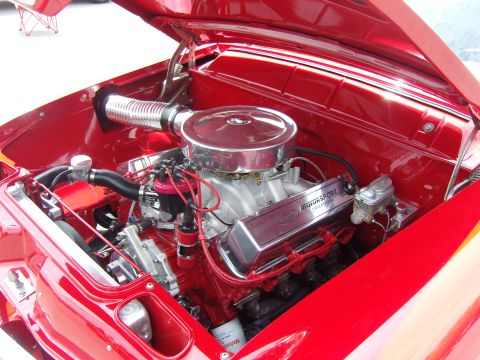 2007 Ford Mustang - The engine bay of a classic car features a polished Ford V8 engine with "Motorsport" inscribed on the valve covers.